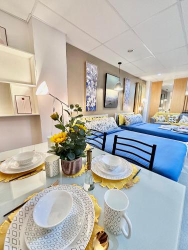 a room with two beds and a table with plates at Smart Condominium in Cagayan de Oro City in Cagayan de Oro