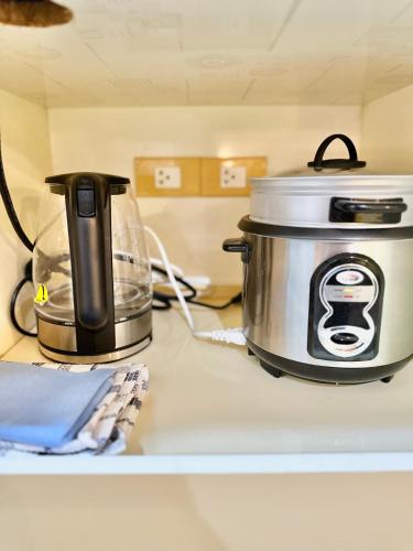 a slow cooker and a toaster sitting on a counter at Smart Condominium in Cagayan de Oro City in Cagayan de Oro