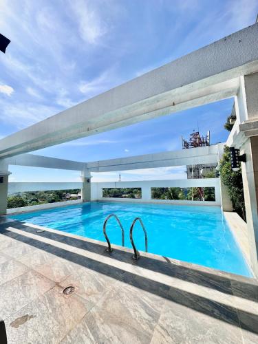 a swimming pool with a pair of tongs in the middle at Smart Condominium in Cagayan de Oro City in Cagayan de Oro