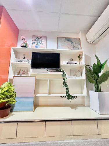 a room with a desk with a computer and plants at Smart Condominium in Cagayan de Oro City in Cagayan de Oro
