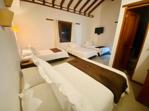 Katil atau katil-katil dalam bilik di Hotel Oasis de la villa