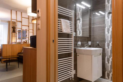 a bathroom with a sink and a shower at LUXURY Apartment Hrebienok D210 in Smokovce