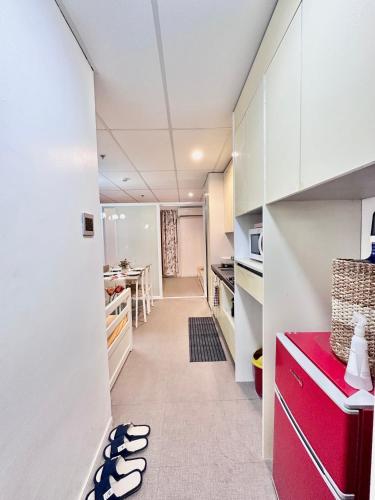 a kitchen with white cabinets and a red counter at 3 Smart Condominium in Cagayan de Oro City in Cagayan de Oro