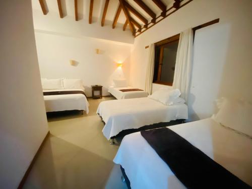 Katil atau katil-katil dalam bilik di Hotel Oasis de la villa