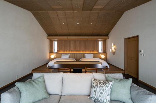 a living room with a couch and a bed at アルカディアリゾート宮古島 in Irabu