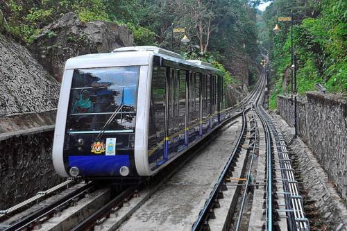 a blue and white train on the tracks at AAA Homestay Georgetown Penang in Ayer Itam