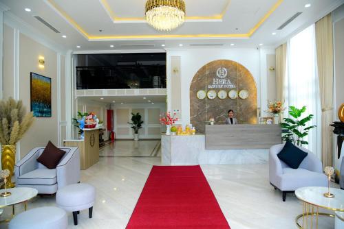 a lobby of a hotel with a red carpet at Hera Luxury Hotel in Ho Chi Minh City