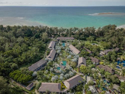 an aerial view of the resort with the ocean in the background at The Slate, Phuket in Nai Yang Beach