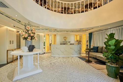 a living room with a table and a chandelier at La Belle Vie Boutique Hotel in Da Nang