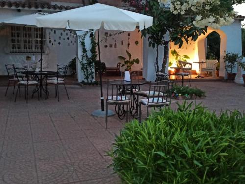 an outdoor patio with tables and chairs and umbrellas at Da Tea in San Teodoro