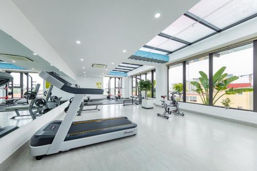 a gym with treadmills and elliptical machines at Phong Lan Apartments in Hai Phong
