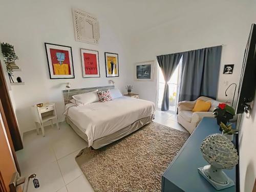 a bedroom with a bed and a couch at Beautiful Penthouse in Punta Cana & Close Beach in Punta Cana