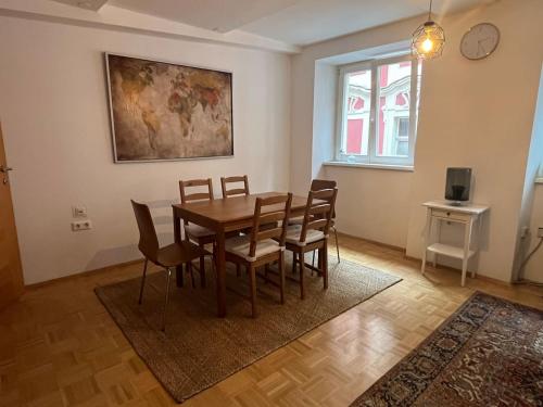 a dining room with a wooden table and chairs at Franziskaner Suites #9 in Graz