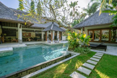 a swimming pool in the backyard of a house at The Maya Seminyak Villas in Seminyak
