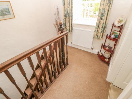 a staircase in a home with a window and a violin at Blacksmith Cottage in Appleby