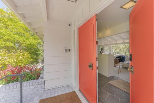 eine rote Tür auf einem Haus mit einer Veranda in der Unterkunft 3900 Palm House on Cabrillo home in Pebble Beach