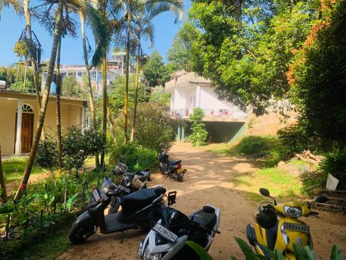 a group of motorcycles parked on a dirt road at Rock View Hostel Ella in Ella