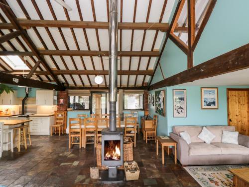 a living room with a wood stove in a room at The Barn in Chippenham