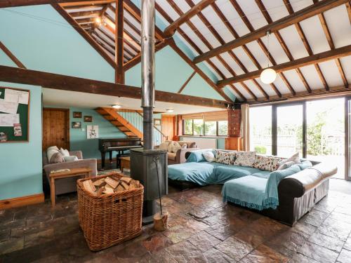 a living room with a couch and a fireplace at The Barn in Chippenham