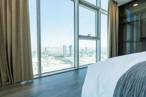 a bedroom with a view of a city at S Plaza Suites Hotel in Seef