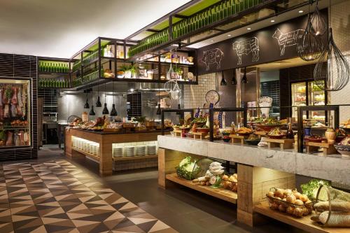 a restaurant with a bunch of food on display at QT Gold Coast in Gold Coast