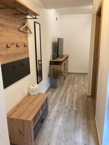 a living room with wooden floors and a tv at Zelena Oaza in Zgornja Kungota