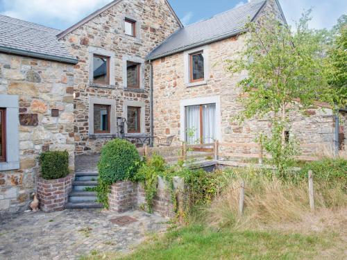 an old stone house with a garden in front of it at Beautiful g te in Jalhay 5 minutes from the Hautes Fagnes in Tiège
