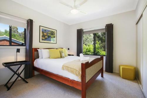 a bedroom with a bed and a window at Brookside in Bright