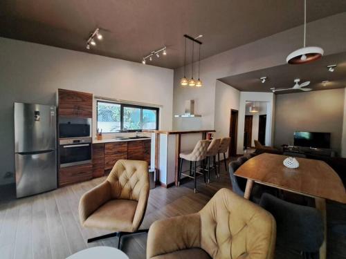 a kitchen and living room with a table and chairs at Tropical 3-bedrooms Coastal Residence Creolia in Grand Baie