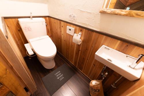a bathroom with a toilet and a sink at Niseko Nikuyadoya in Niseko