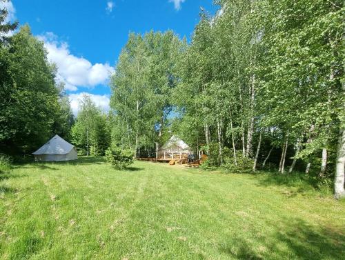 a large yard with a tent and trees at Glamping Stola- Šepot kvetov in Štôla