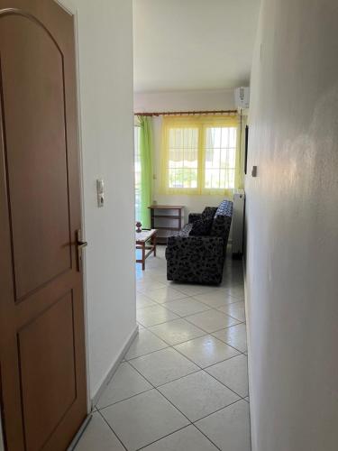 an open door to a living room with a couch at VOULA'S HOUSES in Karlovasi