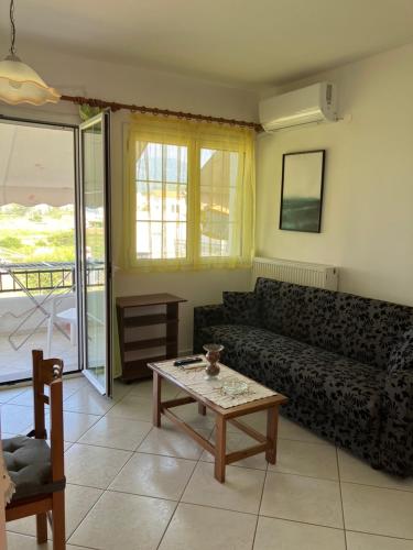 a living room with a couch and a coffee table at VOULA'S HOUSES in Karlovasi