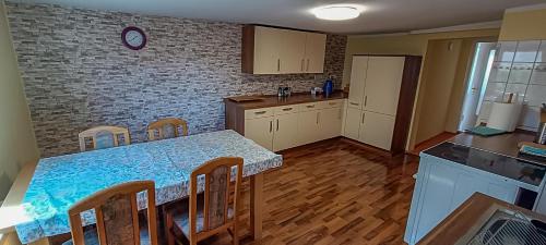 a kitchen with a table and chairs and a brick wall at Gemütliches Haus in Gartz/Oder in Gartz an der Oder