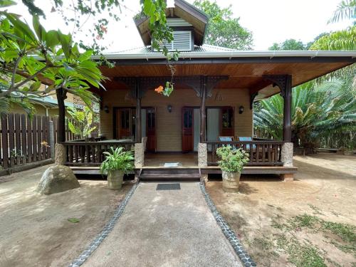 a small house with a porch and a porch at Anse Severe Beach Villas in La Digue