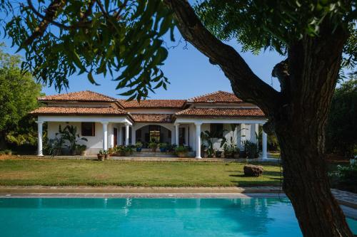 a house with a pool in front of it at Treasure Rock in Kirinda