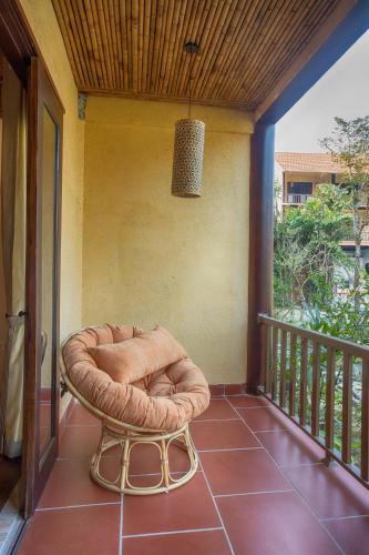 a dog bed sitting on a porch with a balcony at Hồ Đá Cổ Thiên Long Resort Hòa Bình in Hòa Bình