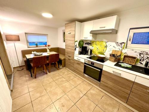 a kitchen with a table and a dining room at Ferienwohnung No 1am Golfplatz in Wiesmoor