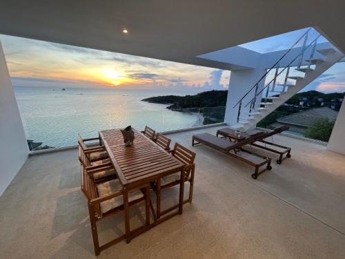 a dining room with a view of the ocean at The Beach Residence in Koh Samui