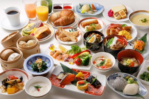 a table with many plates of food and drinks at Solaria Nishitetsu Hotel Taipei Ximen in Taipei