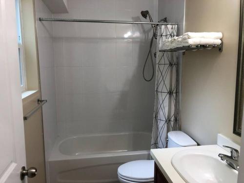 a bathroom with a shower and a toilet and a sink at Modern Private Suite Close to Everything in Vancouver