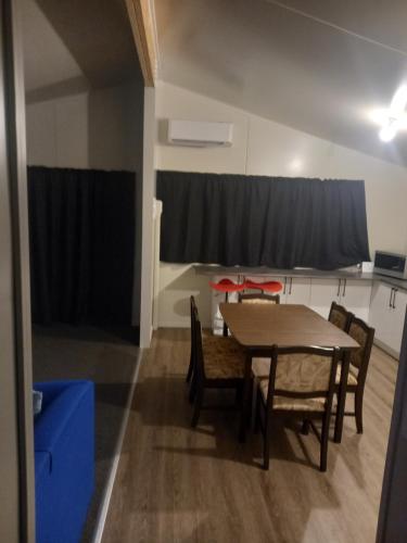 a dining room with a table and chairs at Rimu in Ohakune