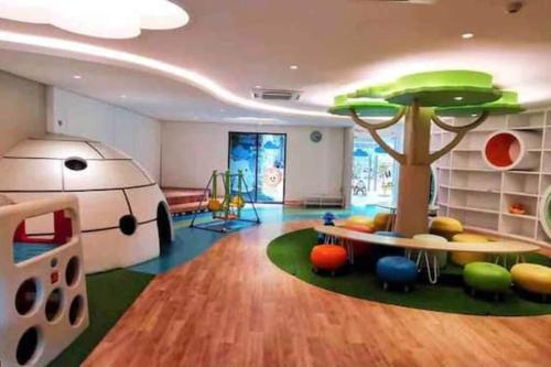 a room with a play area with a tree in it at Vimalla Hills Villa Resort Exclusive Villa Puncak in Gadok 1