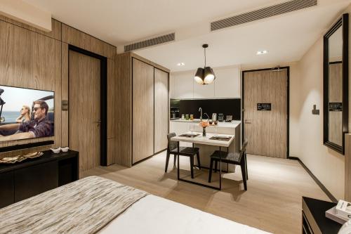 a bedroom with a dining room and a kitchen at Ascott Star KLCC Kuala Lumpur in Kuala Lumpur