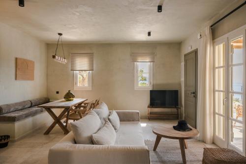 a living room with a couch and a table at Uberina - Olea Di Assos Villas in Asos