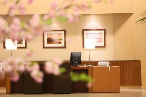 an office with a desk with a computer on it at ANA Crowne Plaza Kobe by IHG in Kobe