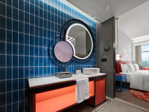 a bathroom with a sink and a mirror at Dhawa Xi'an Chanba in Xi'an