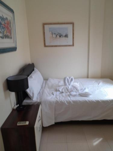 a hotel room with a bed with a bow on it at Bayswater subdivision guest house .. in Agus