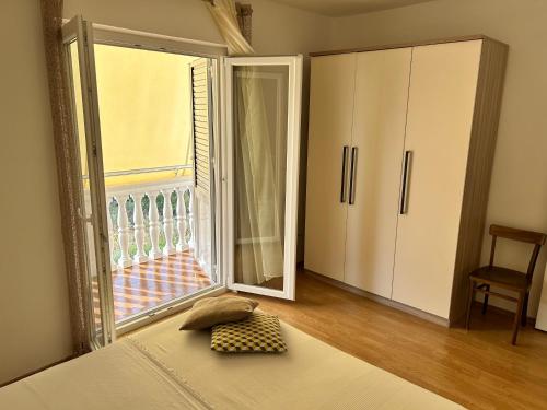 a bedroom with a bed and a sliding glass door at Villa Roseal in Povljana