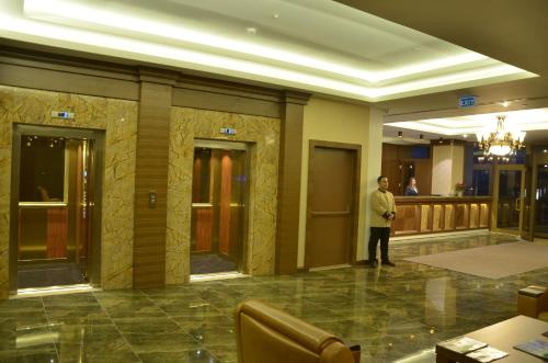 a man standing in a lobby of a hotel at Adranos Hotel in Bursa